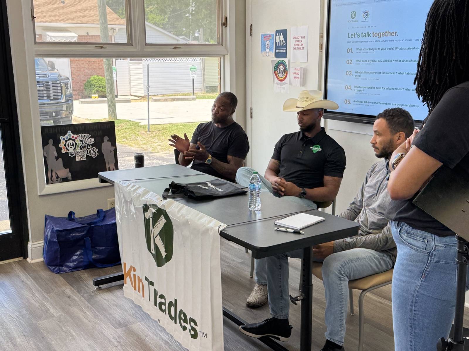 Three Cumberland County owner-operators seated on a panel, taking questions from the cohort in front of a KinTrades banner.
